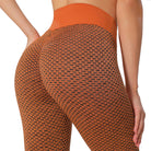Textured scrunch high-waist gym leggings in orange, rear view — Luna Forza Aria